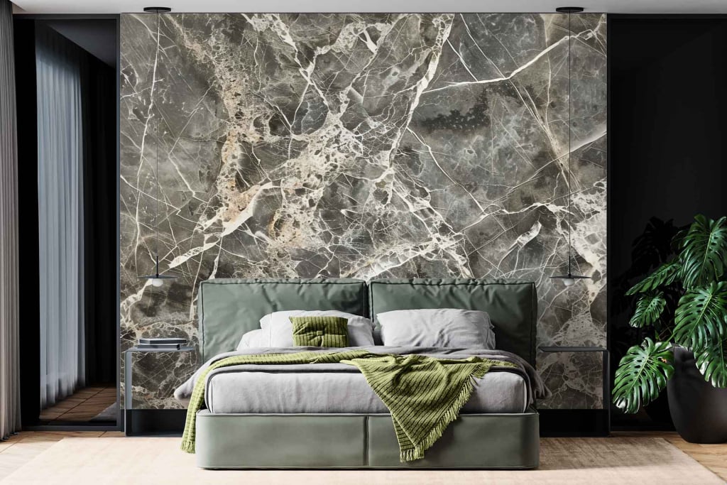 The large accent wall features a unique marble pattern, predominantly in shades of white and gray with subtle hints of green. The intricate veins within the marble create a dynamic texture, blending seamlessly with the room’s natural theme. Marble, gray, white, green veins.