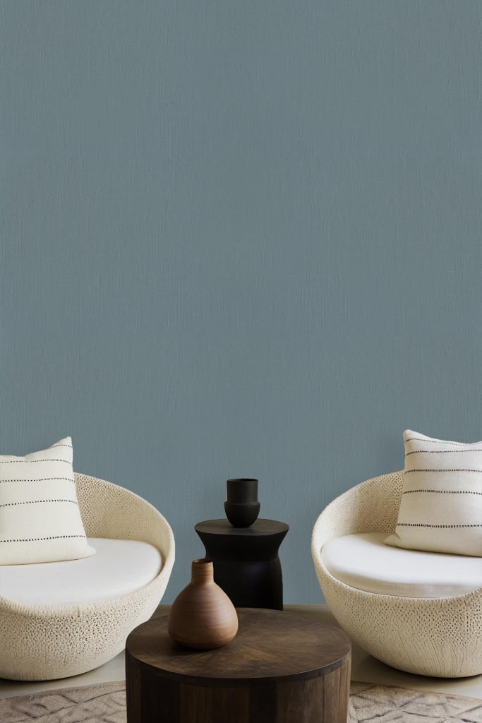 Wall painted solid muted teal color evoking drift and calm.