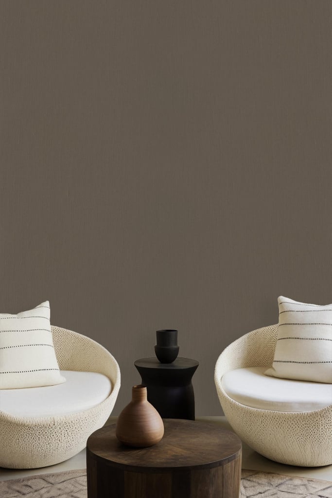 Solid taupe wall, plain background, no patterns.