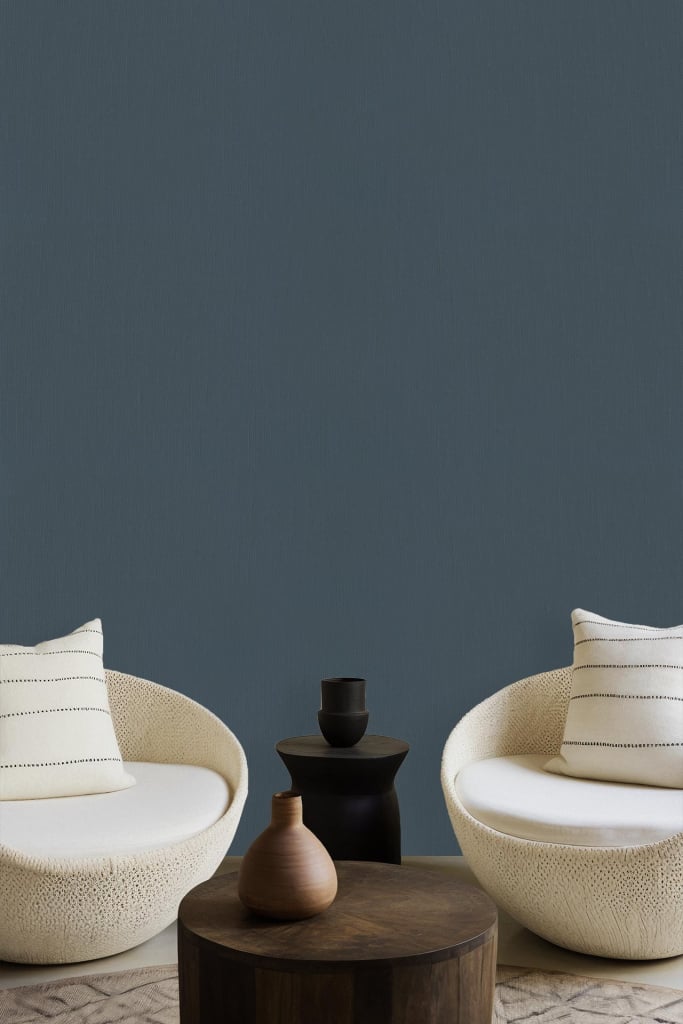 Muted teal wall, solid color.