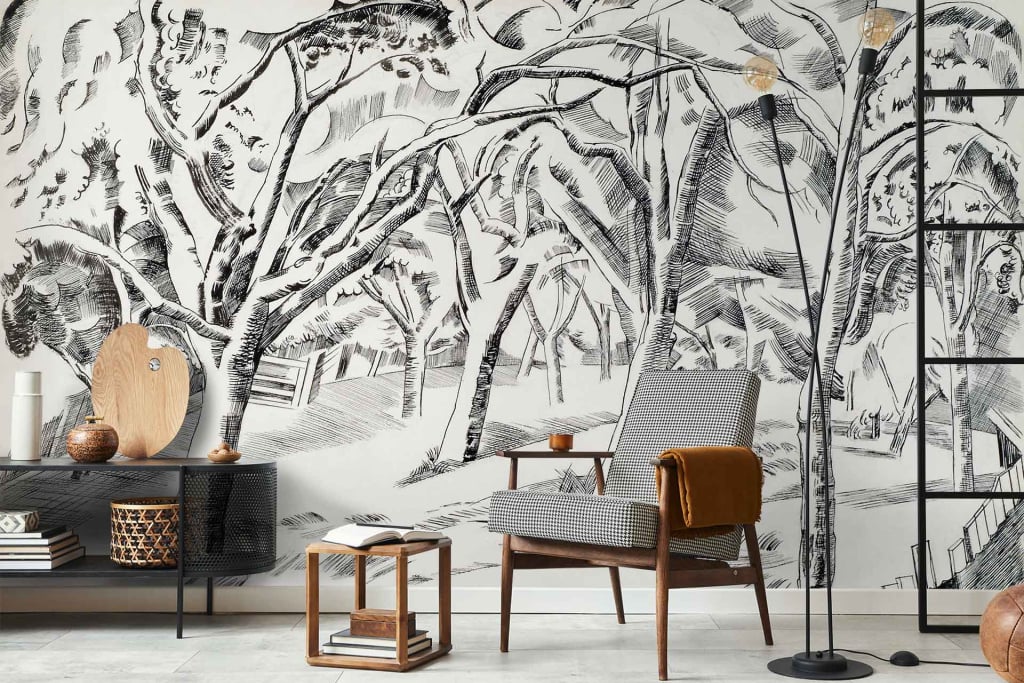 The monochrome wallpaper features a detailed tree mural that brings cool vibes to the living room. The design includes intricate black and white tree branches and leaves, creating a striking contrast. The grayscale patterns evoke a serene forest atmosphere, achieving contemporary elegance with its minimalist color palette of black, white, and various shades of gray. This sophisticated wallpaper acts as a focal point in the space while enhancing the overall modern aesthetic.
