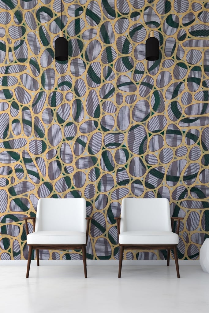 Colorful geometric-patterned wallpaper, interconnected oblong shapes, green, gold, black.