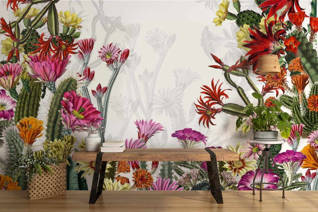 The wallpaper features a dynamic mural with colorful floral and cactus elements. Red, pink, orange, and yellow flowers blend amid lush green foliage. The design showcases an eye-catching mix of vibrant hues and botanical patterns.