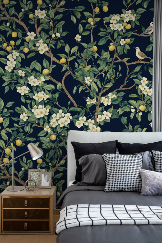 Wallpaper with a dark background, decorated with green leaves, white flowers, yellow lemons, and small birds on branches.