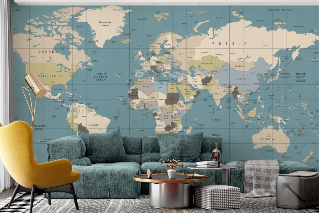 The wallpaper is a large map of the world mural, featuring detailed geographical elements and various color tones such as blues for oceans, greens and browns for landmasses, along with intricate labels and borders. It has a vintage appearance with muted colors that add to the travel-inspired theme of the room.