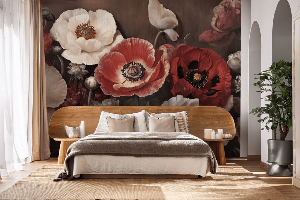 Large wallpaper mural featuring bold red and white poppies dominates the wall behind the bed, with prominent green stems and leaves adding contrast. The Poppy Parade pattern stands out as a vibrant floral accent in the room.