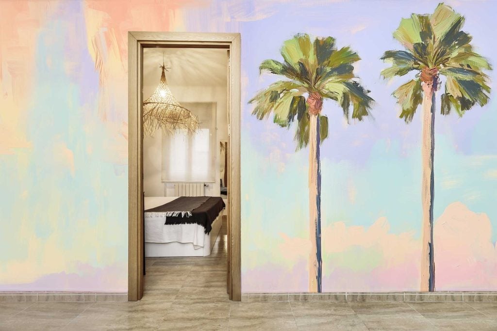 The wallpaper is a colorful mural with a dream-like quality, featuring two palm trees against a pastel background.