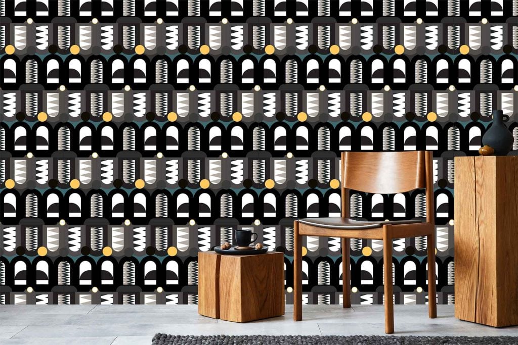 Bold geometric-patterned wallpaper with abstract shapes; colors: black, white, gold.