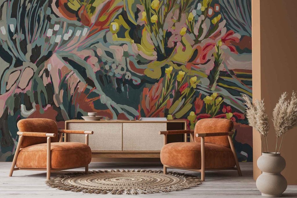 Large abstract floral mural from the Amplify series; features bold, colorful flower motifs with sweeping brushstrokes. Dominant colors include vibrant pink, orange, teal, yellow, and touches of navy and white. The design is expressive and modern with layered petals and organic shapes creating a dynamic wall statement.