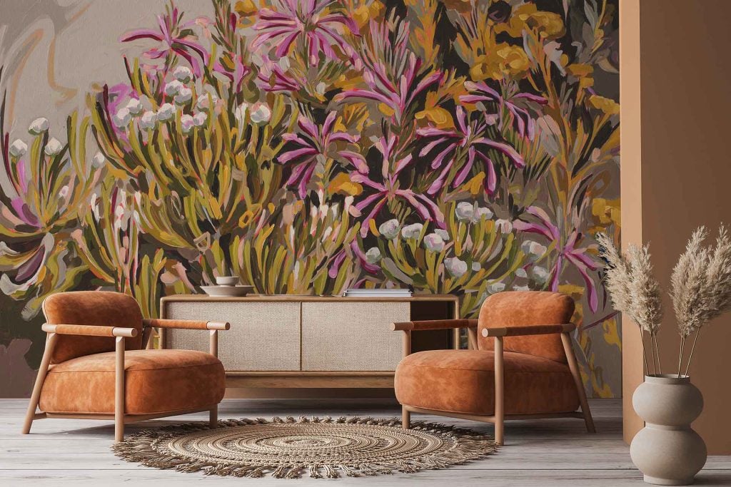 The wallpaper features a vibrant floral mural with bold pink, yellow, and green hues. Large flowers and leafy patterns create an eye-catching, colorful backdrop.