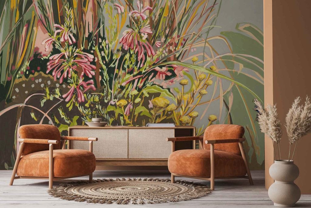 The wallpaper features a colorful floral mural with large painted flowers in shades of pink, orange, and yellow. Green leaves and botanical elements are interwoven throughout the vibrant, nature-inspired design.