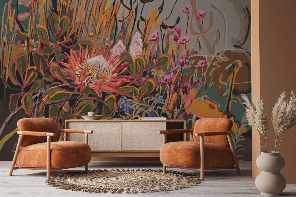 Large botanical wallpaper featuring bold, colorful flowers such as King Protea, vibrant greenery, and various lush leaves in shades of pink, coral, burgundy, sage green, and deep green.
