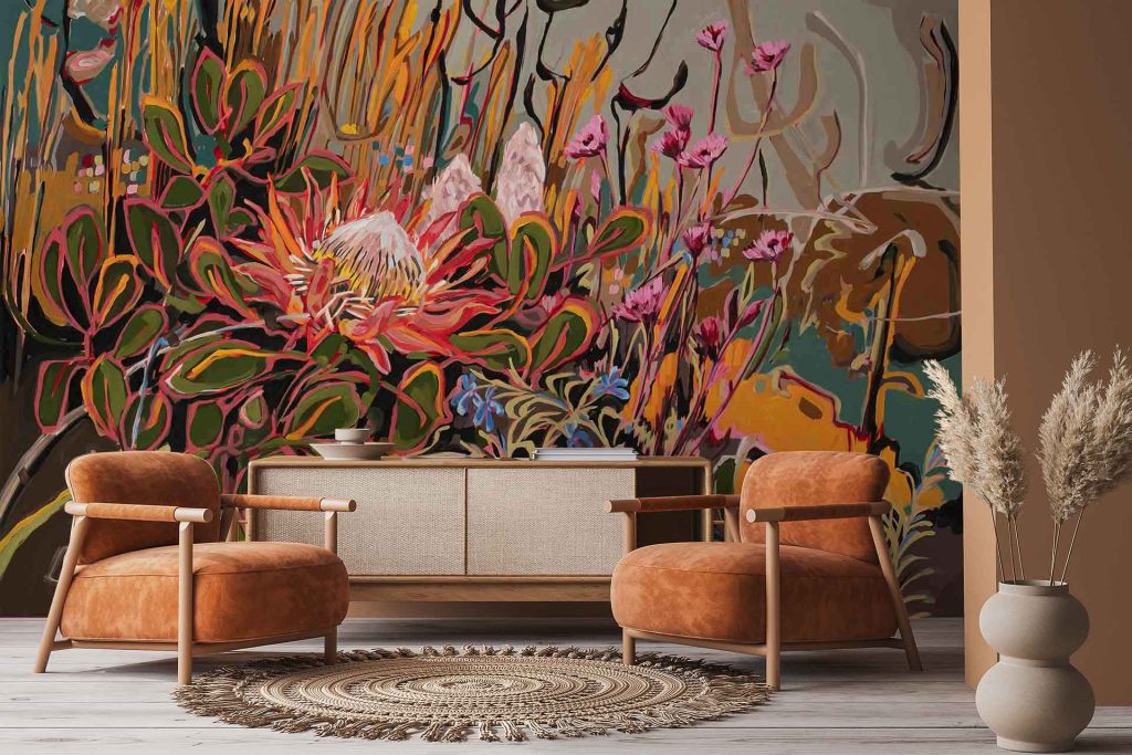 The wallpaper features a bold, colorful floral mural with large King Protea flowers and lush green leaves. Vibrant pinks, reds, and greens dominate the artistic background design.