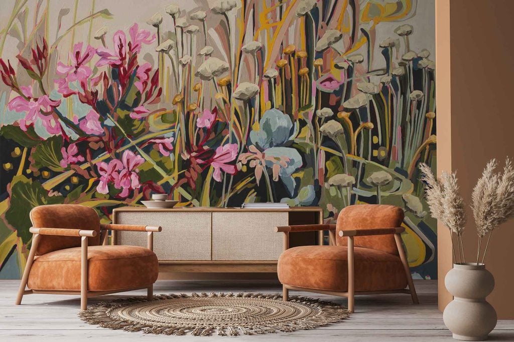 Floral mural wallpaper features bold, oversized botanical motifs from the Amplify series. Elements include abstract flowers, lush leaves, and organic shapes in earthy tones—terracotta, blush pink, olive green, cream, and muted gold—creating a warm modern backdrop.