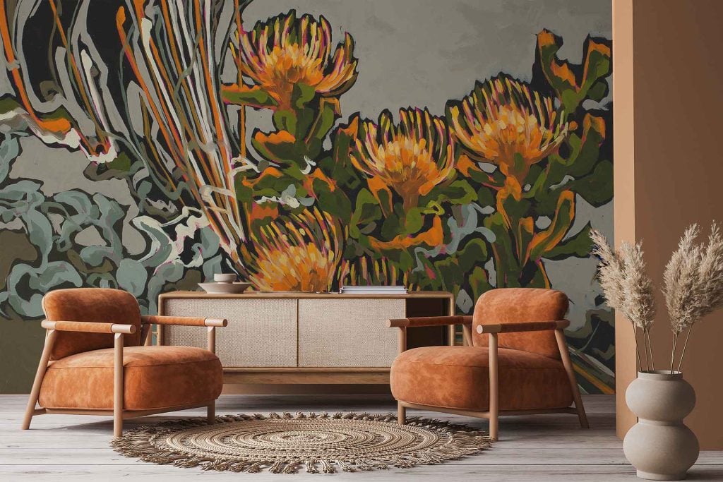 The wallpaper features a bold mural of large, abstract flowers and leaves in vibrant hues such as coral, teal, ochre, emerald green, blush pink, deep blue, and mustard yellow. The design incorporates oversized petals and sweeping botanical shapes with painterly textures for a modern artistic look.