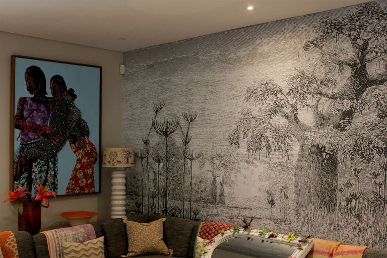 Large black-and-white mural of trees. Monochrome palette featuring shades of black, gray, and white. Detailed tree patterns and textures dominate the wall design.