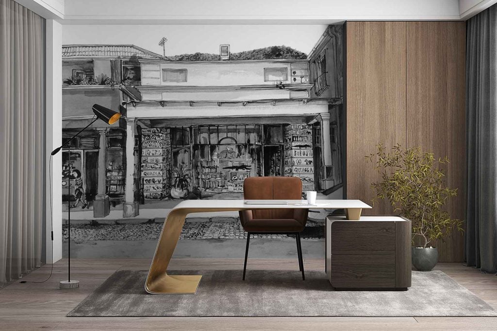 The wallpaper is a large wall mural featuring a monochrome street scene. It depicts detailed shopfronts and buildings, rendered in shades of black, white, and gray. Architectural elements include windows, awnings, doors, and facades lining the street. No color accents—completely grayscale for a contemporary urban vibe.