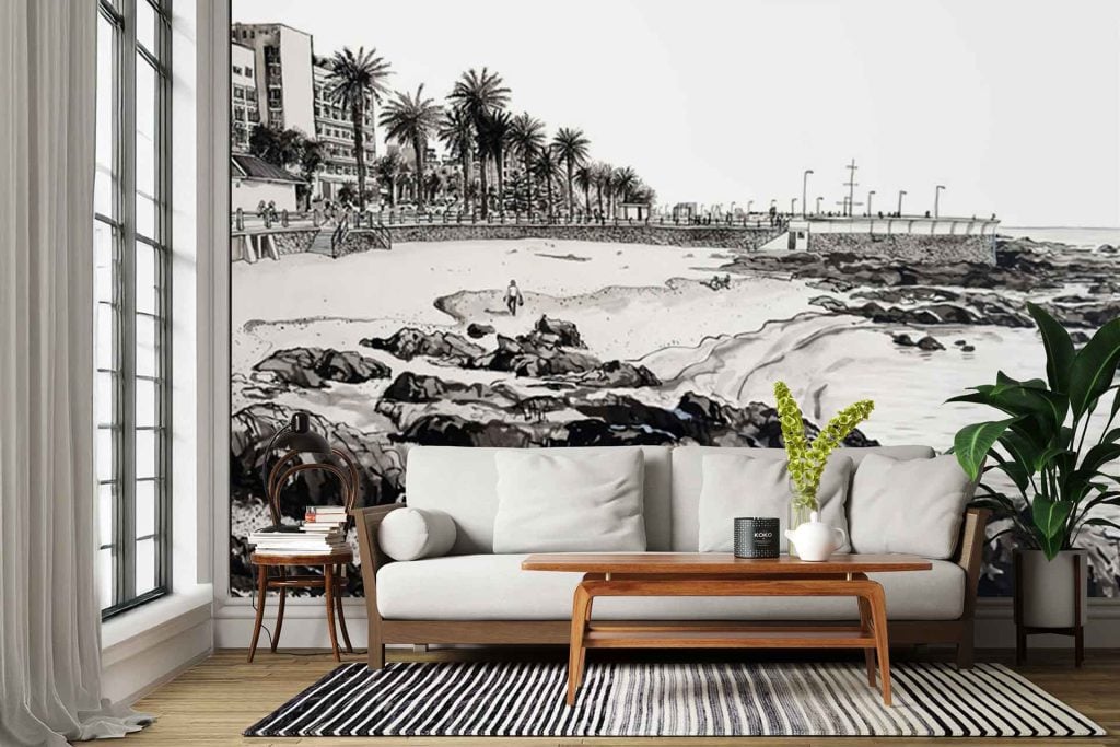 Black-and-white wall mural featuring Rocklands’ beach scene: detailed palm trees, coastal buildings, and dramatic rocky outcrops. Monochrome tones; high-contrast lines; intricate landscape.
