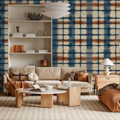 Wallpaper features a plaid design with intersecting stripes in deep blue, vibrant orange, and crisp white, inspired by Orion’s colors. The geometric pattern creates a cozy yet dynamic accent wall, blending cool blues with warm orange tones and clean white lines.