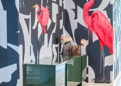 The wallpaper features large pink birds, bold abstract black and white shapes, and a lively pattern. Colors present: pink, black, white.