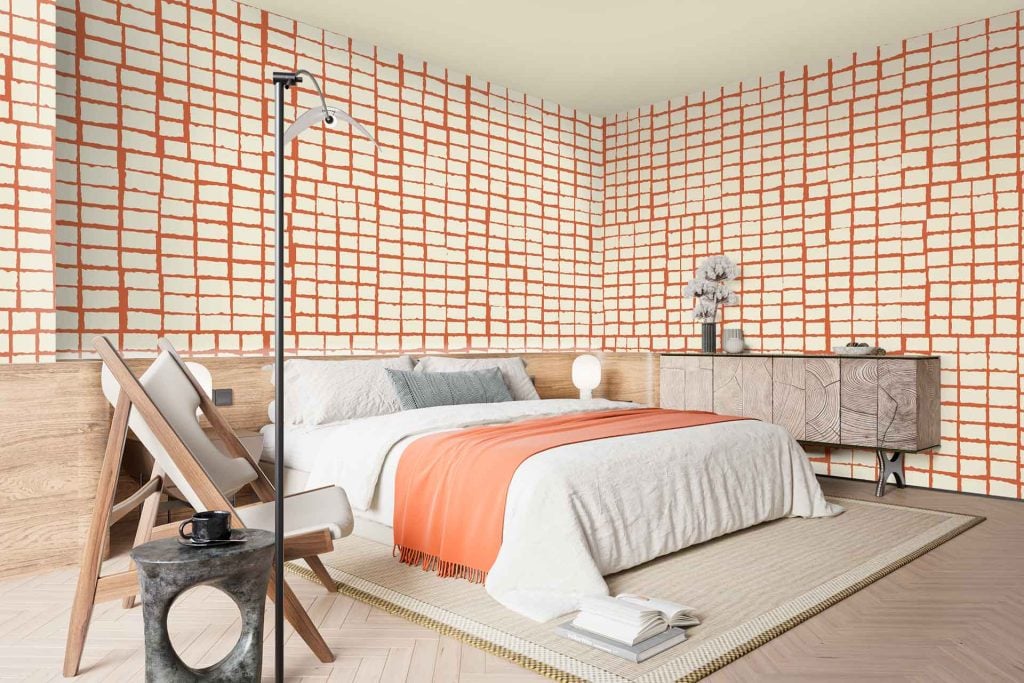 The wallpaper features a modern grid pattern composed of crisp, Orion white squares intersected by bold orange lines, creating a striking geometric design. The main elements are straight horizontal and vertical orange lines on a clean white background, forming a uniform and minimalist grid motif throughout the surface. Colors: bright white (Orion), vivid orange.