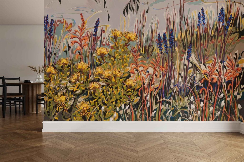 Wall mural wallpaper features vibrant wildflowers, including Pincushion and Watsonia blooms in vivid pinks, oranges, and reds among tall green grasses.