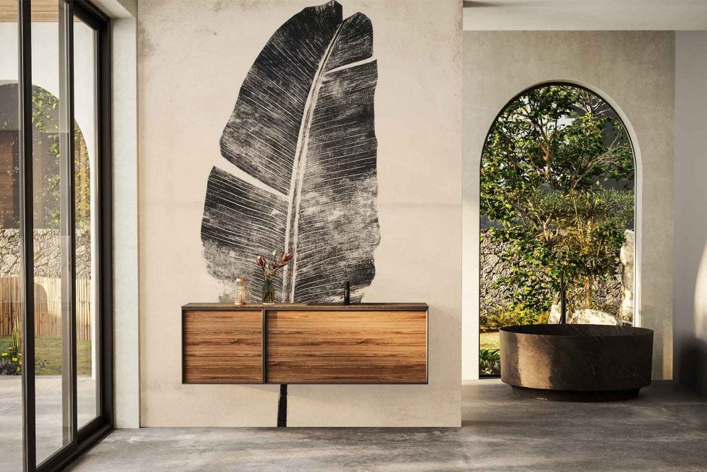 Black leaf mural wallpaper with bold, oversized botanical patterns dominates the bathroom wall, featuring deep black hues and fine vein detailing against a light backdrop.