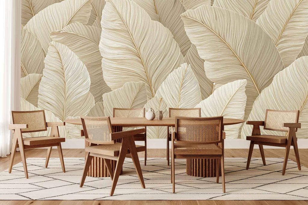 Large beige mural with leaf patterns, featuring natural and stylish motifs. The wallpaper displays oversized botanical elements in soft neutral tones, enhancing the backdrop with subtle earthy shades and organic shapes.