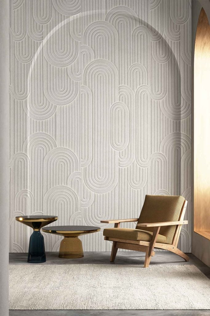 Textured wall with an abstract, geometric pattern in neutral tones; wallpaper features shapes and lines in beige, taupe, ivory, and soft gray for a subtle modern look.