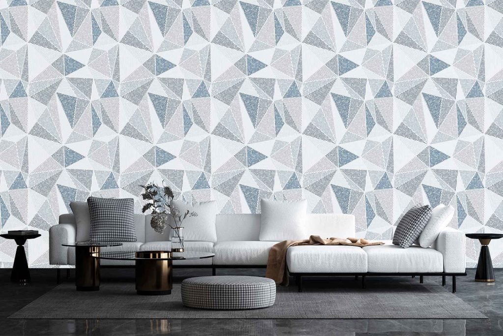 Geometric wallpaper in the living room featuring shades of gray, white, and blue with bold patterns and shapes.