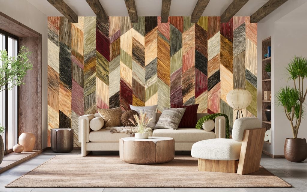 Chevron-patterned accent wall with bold zigzag stripes in varying shades and colors, creating a striking backdrop in the room. The dynamic Crazy One wallpaper design is eye-catching and vibrant, making it a standout feature.
