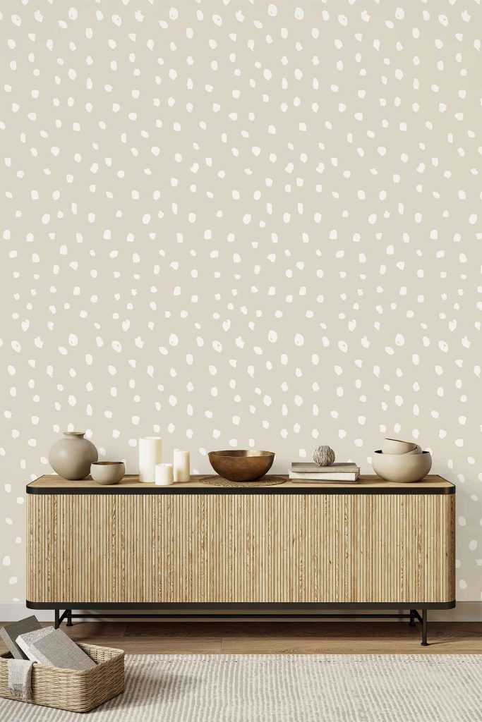 Beige wallpaper featuring an irregular white polka dot pattern.