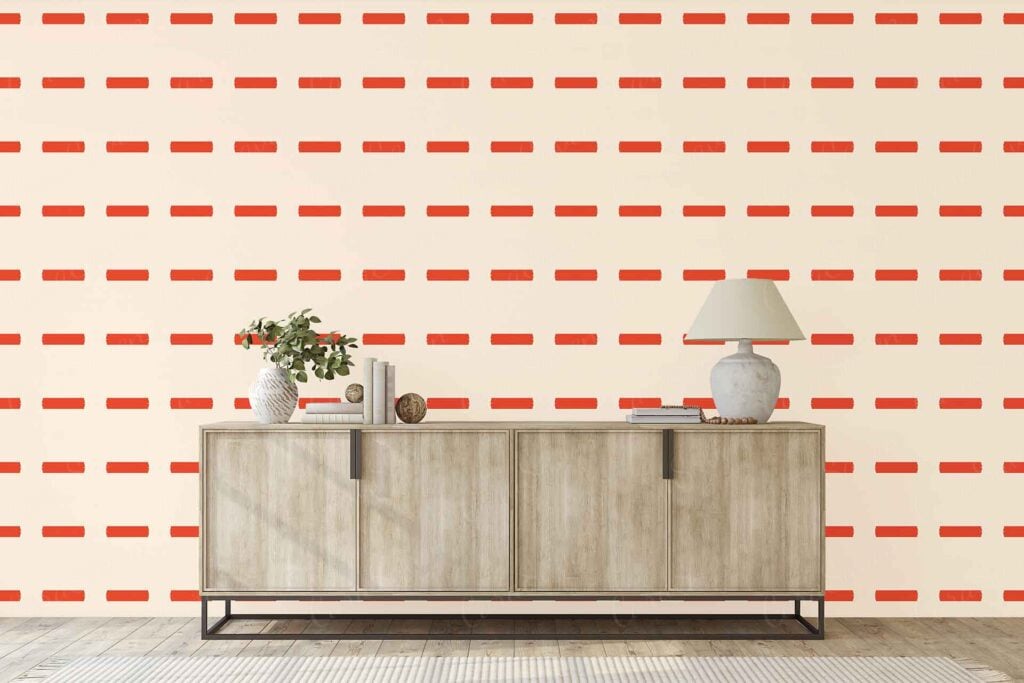 Cream wall wallpaper with horizontal red dashed stripes, creating a subtle yet distinctive pattern.