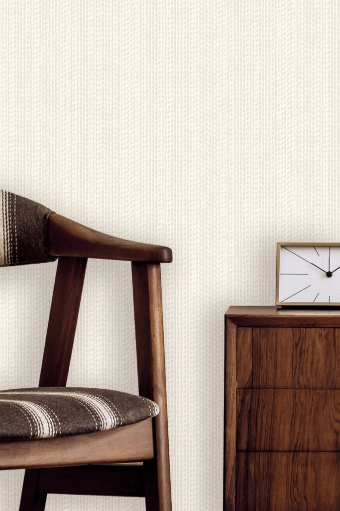 Textured off-white wallpaper with subtle raised patterns creates a visually interesting background. The wallpaper features various elements and patterns in shades of cream, ivory, and light beige.