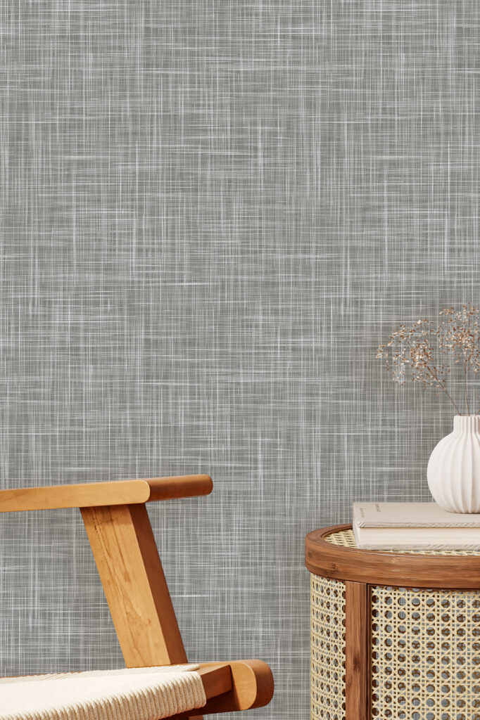 A textured gray wallpaper featuring subtle variations in tone, adding depth and a modern feel to the room’s background.
