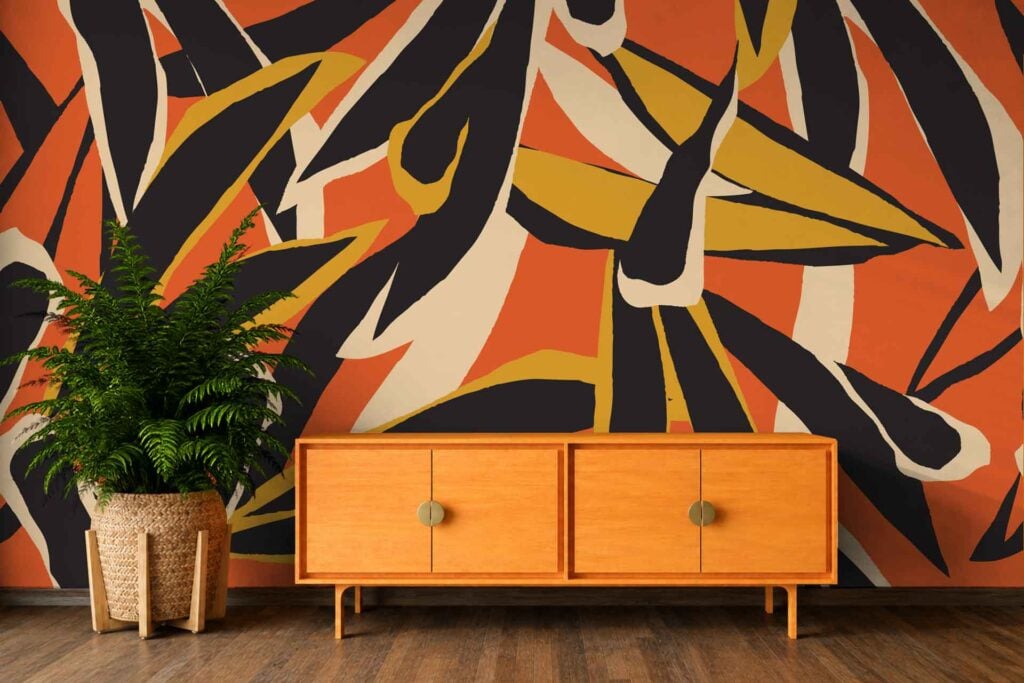 Abstract mural wallpaper featuring bold black, orange, yellow, and cream shapes in an eye-catching modern design.