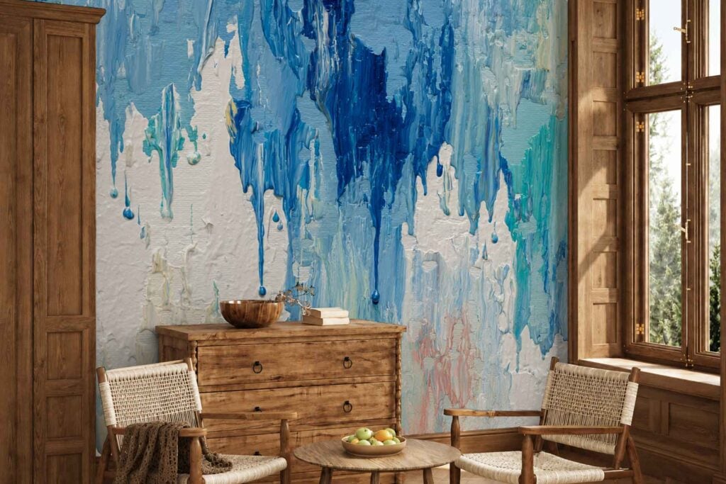 Large abstract wall mural with overlapping drips of blue, white, and turquoise paint, creating a vibrant and artistic backdrop.