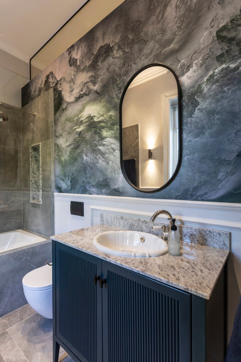 Marbled wall wallpaper with swirling shades of white, gray, and subtle blue patterns creates a modern, elegant backdrop.