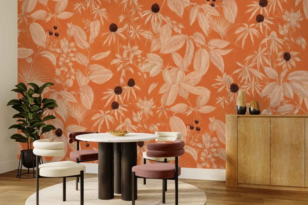 Bold orange wallpaper with large floral and leaf patterns in contrasting hues, featuring intricate petals, sweeping leaves, and vibrant color contrasts for a striking decorative effect.