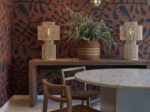 Wallpaper features a bold abstract pattern with dark brown and black shapes, creating a striking visual contrast on the wall.