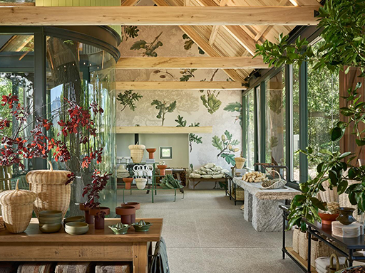 Nature-themed wallpaper featuring leafy green patterns and subtle floral accents in soft earth tones adds a vibrant, botanical touch to the space.