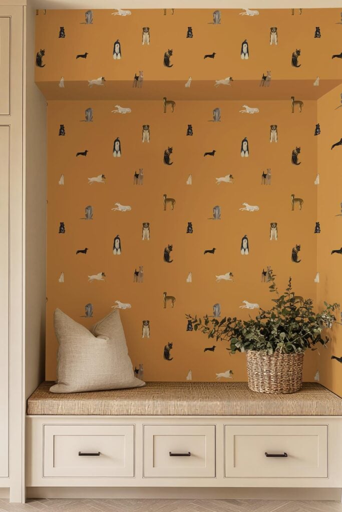 Mustard-yellow wallpaper on the wall and ceiling features illustrated cats in playful poses, grouped together in various colors. The cat illustrations are reminiscent of Schnauzer & Co designs, creating a whimsical and cozy atmosphere with vibrant feline art.