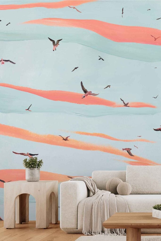 Wallpaper features a mural of flying birds amidst pastel orange and blue clouds, creating a serene sky-like effect. Key elements: birds, pastel clouds, orange, blue, sky wallpaper.