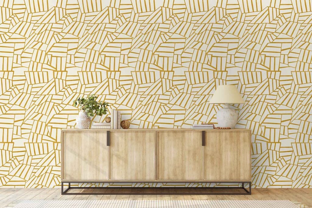 Geometric gold and white patterned wallpaper with bold shapes and metallic accents forms the backdrop.