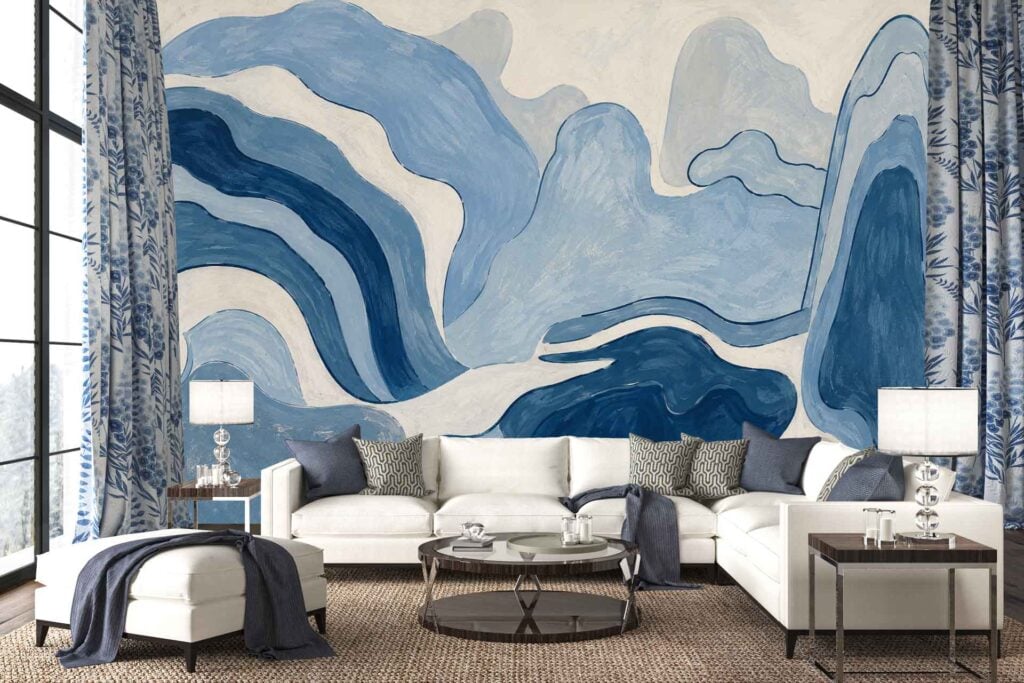 Abstract blue and white mural wallpaper with bold, sweeping blue shapes and crisp white accents; the design features a mix of light and dark blue tones that echo the room’s overall color palette.