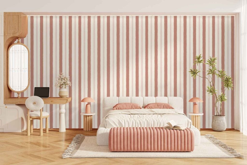 Pink-striped accent wallpaper with alternating white and pink vertical lines creates a bold, modern statement in the bedroom. The vibrant stripes stand out as a key design element and add color to the space.