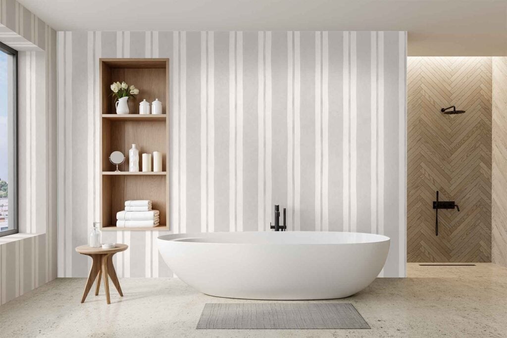 Vertical striped wallpaper in the bathroom, featuring alternating light and dark tones that add a modern touch to the space. Stripes run floor to ceiling, creating a sense of height and visual interest in neutral colors.