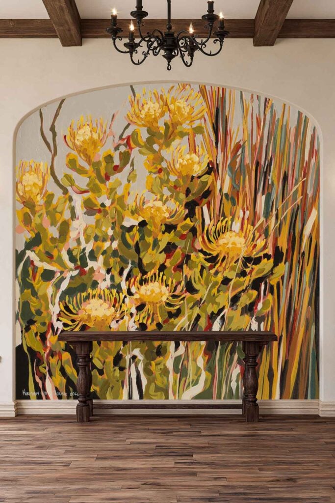 Wallpaper features bright yellow protea flowers with detailed green and orange foliage. The botanical mural design fills an arched alcove, showcasing vivid floral patterns and bold natural colors.
