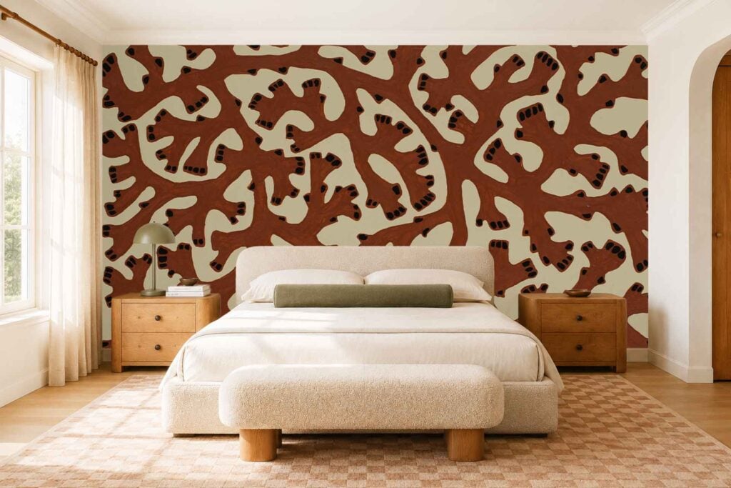 Large accent wall mural with bold abstract patterns in coral and beige tones, featuring sweeping organic shapes and soft color transitions. The wallpaper stands out as the main visual element in the room.
