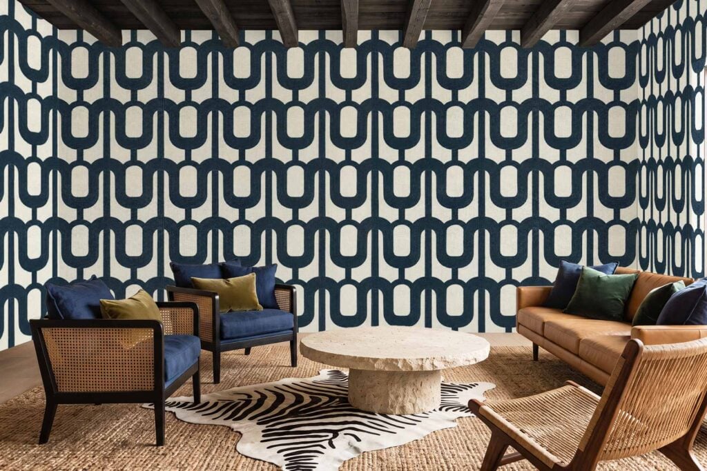 Patterned wallpaper with bold navy geometric shapes stands out in the modern living room, featuring striking blue tones and angular designs perfect for those seeking unique, eye-catching wall decor.
